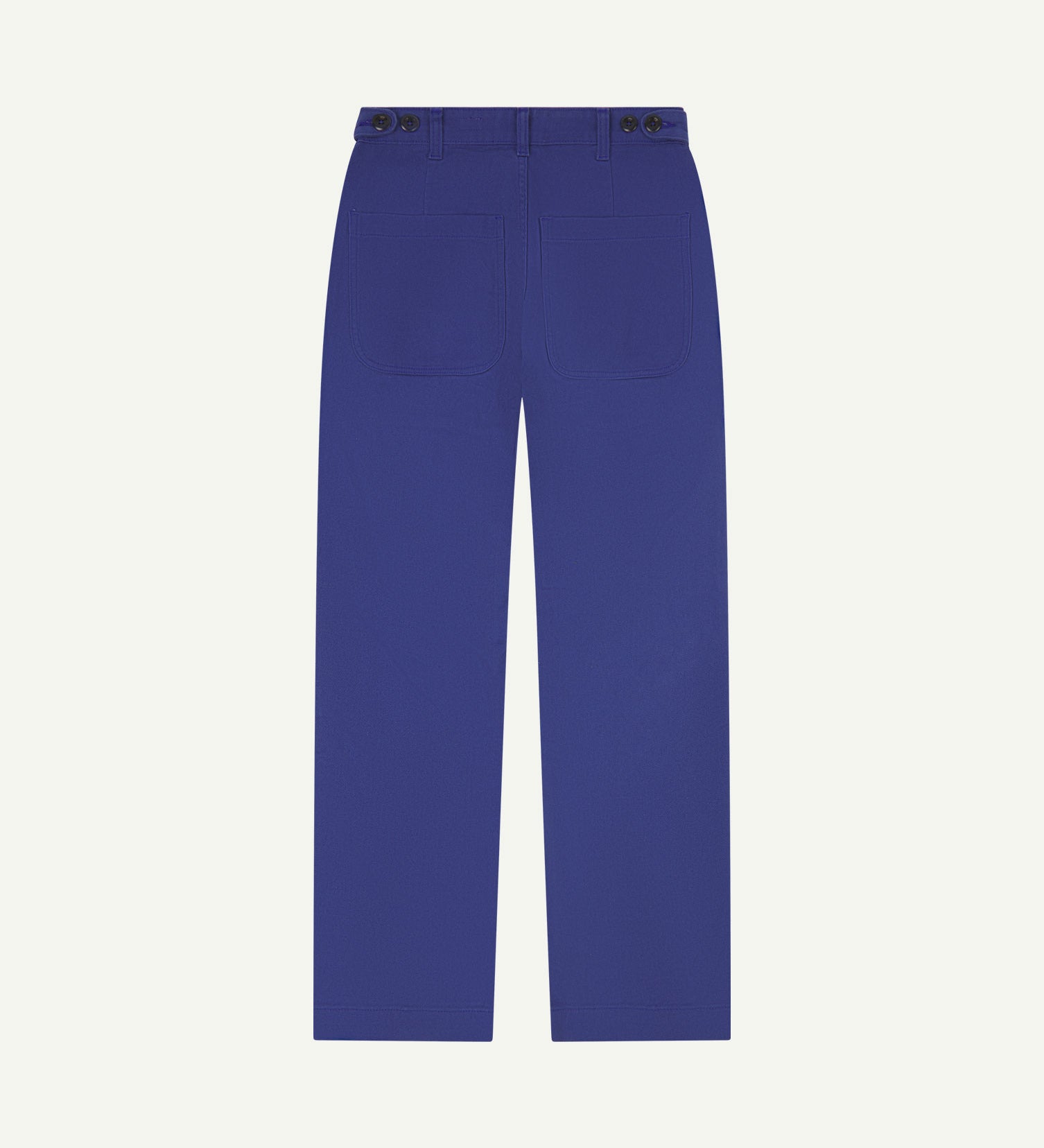 Back flat view of 5013 Uskees drill straight leg pants in ultra blue, with focus on on rear pockets and adjustable waistband with corozo buttons.