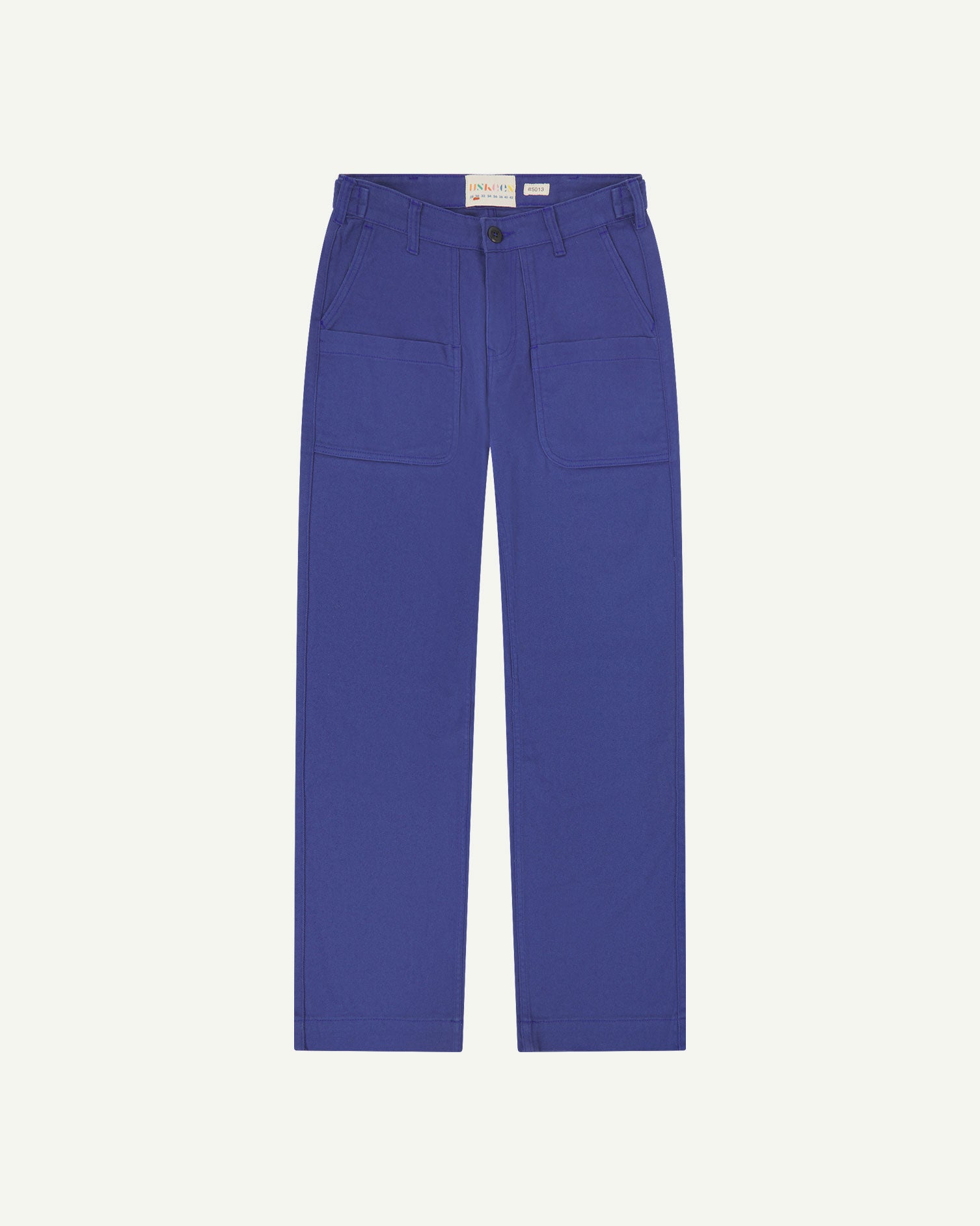 Front flat view of 5013 Uskees drill straight leg pants in ultra blue,with focus on front pockets, layered pockets, belt loops and Uskees branding label.
