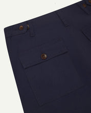 Reverse close-up of cargo pocket detailing and corozo buttons of the midnight blue 5014 pants from Uskees.