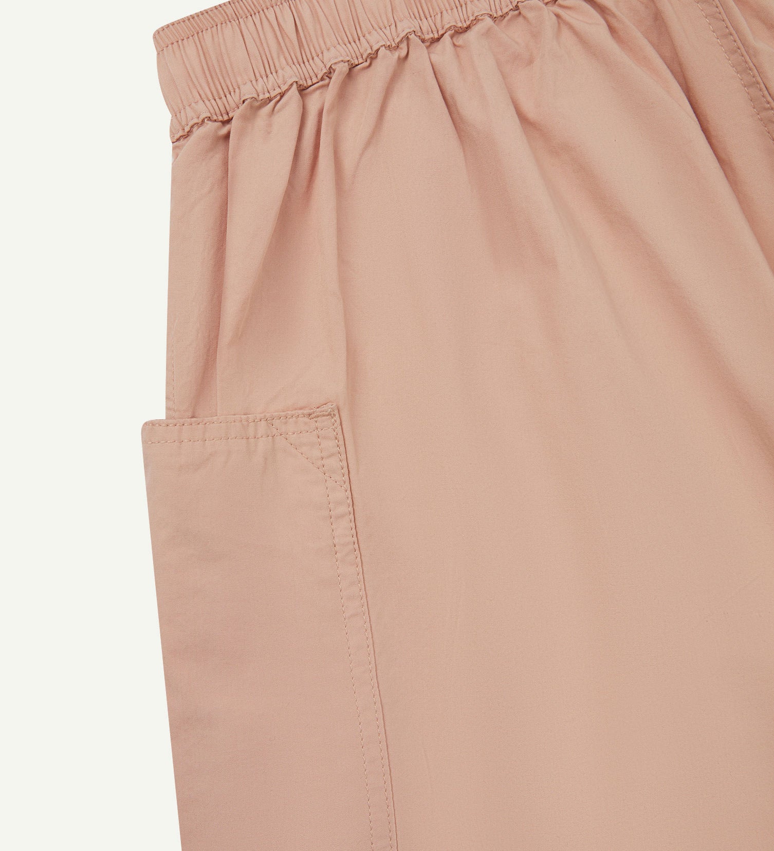 Close angled view of the lightweight elasticated waist of the dusty pink-green #5015 Uskees shorts.