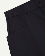 Close-up of the left pocket and stitching of the lightweight organic midnight blue-green cotton shorts.