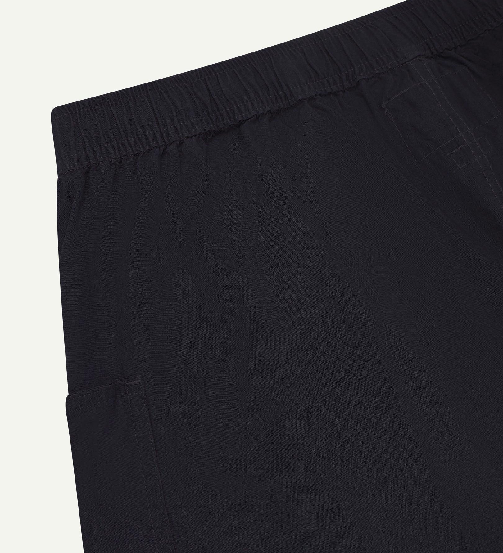 Close angled view of the lightweight elasticated waist of the midnight blue-green #5015 Uskees shorts.