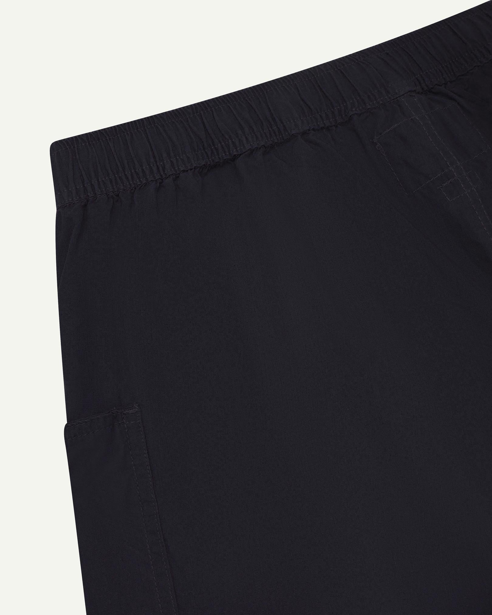 Close angled view of the lightweight elasticated waist of the midnight blue-green #5015 Uskees shorts.