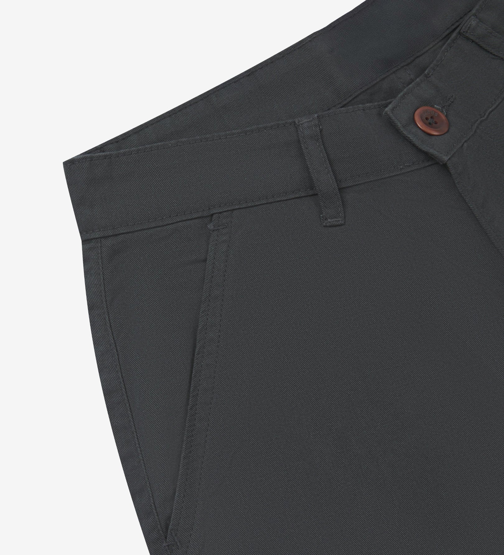 Close-up front view of the left-front pocket, belt loops and Corozo button fastening the of charcoal grey heavyweight twill pants.