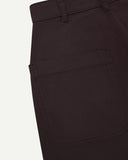 Close-up reverse view of Uskees 'dark plum' heavyweight drill work pants with focus on left rear pocket and belt loops.