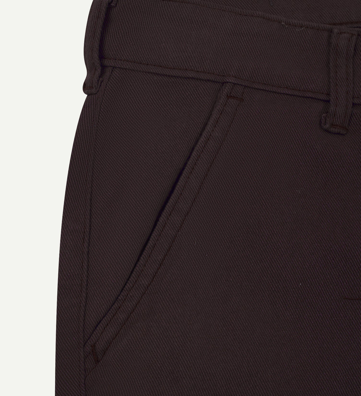 Close-up front view of the left-front pocket detail and belt loops of the 'dark plum' heavyweight drill pants.