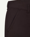Close-up front view of the left-front pocket detail and belt loops of the 'dark plum' heavyweight drill pants.
