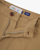 Close up view of 5016 Uskees men's organic twill khaki 'commuter' trousers showing the zip and button fly and brand label.