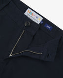 Close up view of 5016 Uskees men's organic twill midnight blue 'commuter' trousers showing the zip and button fly and brand label.