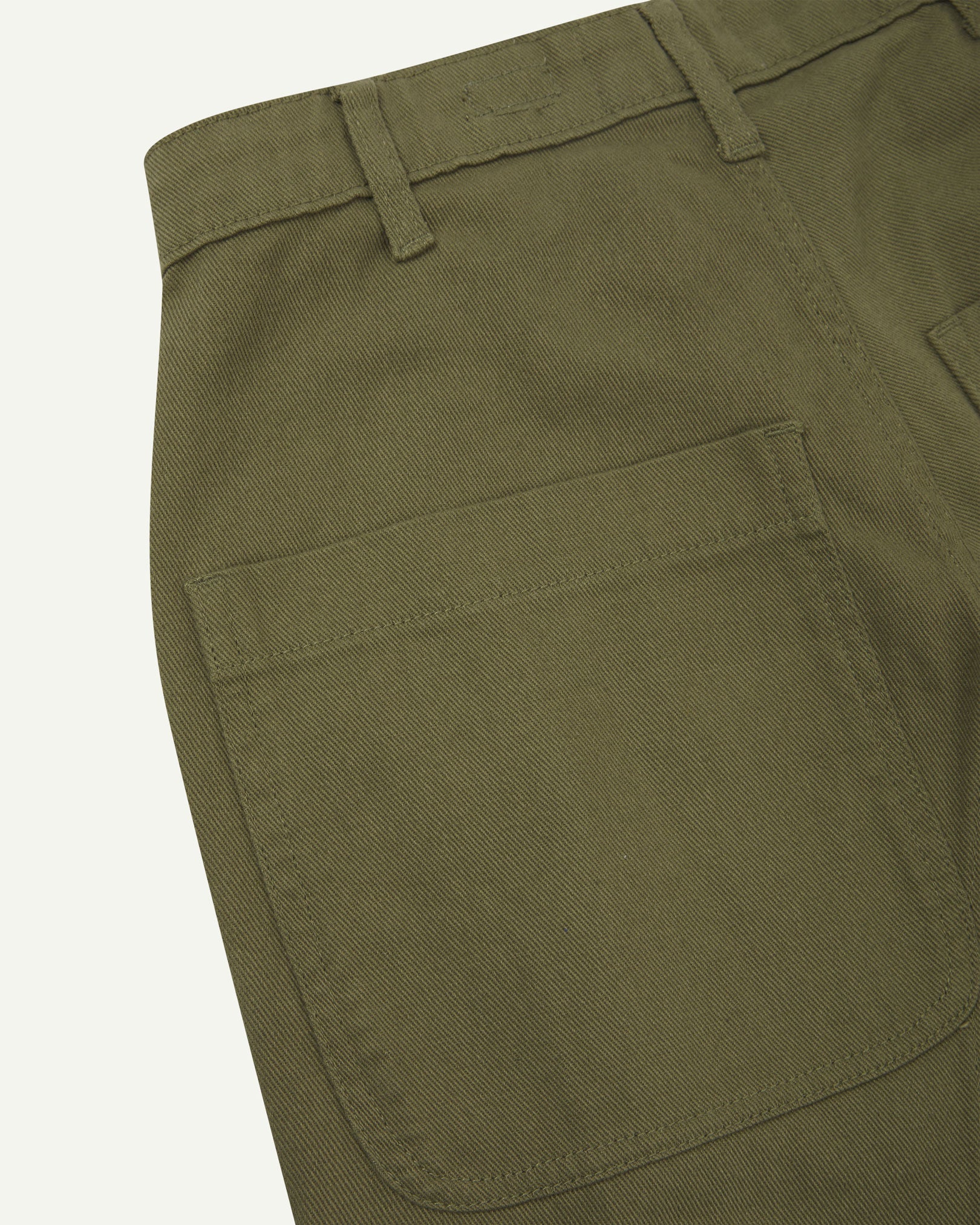 Close-up reverse view of Uskees moss green heavyweight drill work pants with focus on left rear pocket and belt loops.
