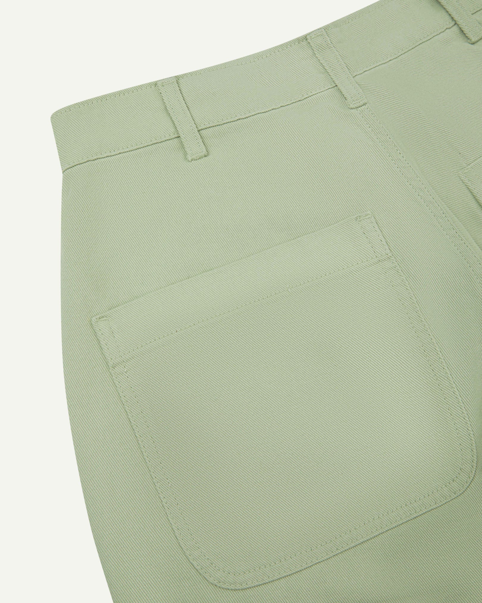 Close-up reverse view of Uskees silver-grey heavyweight drill work pants with focus on left rear pocket and belt loops.