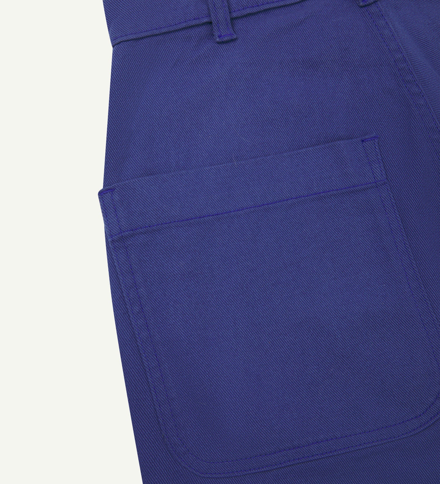 Close-up reverse view of Uskees ultra-blue heavyweight drill work pants with focus on left rear pocket and belt loops.