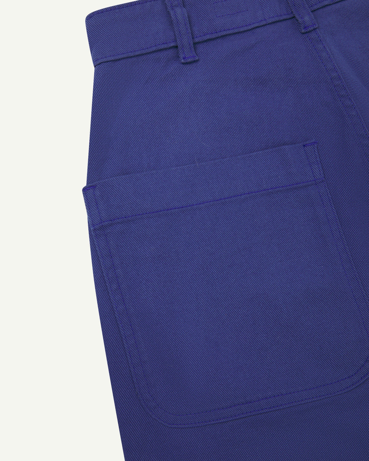 Close-up reverse view of Uskees ultra-blue heavyweight drill work pants with focus on left rear pocket and belt loops.