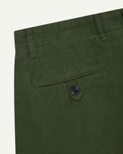Close up back shot of Uskees 5018 cord boat pants in coriander green with focus on neat back pocket secured with Corozo button and belt loops.