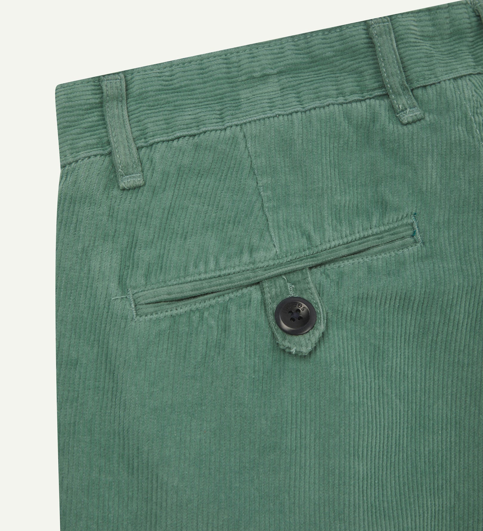 Close up back shot of Uskees 5018 cord boat pants in eucalyptus with focus on neat back pocket secured with Corozo button and belt loops.