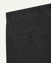 Close up back shot of Uskees 5018 cord boat pants in faded black with focus on neat back pocket secured with Corozo button and belt loops.