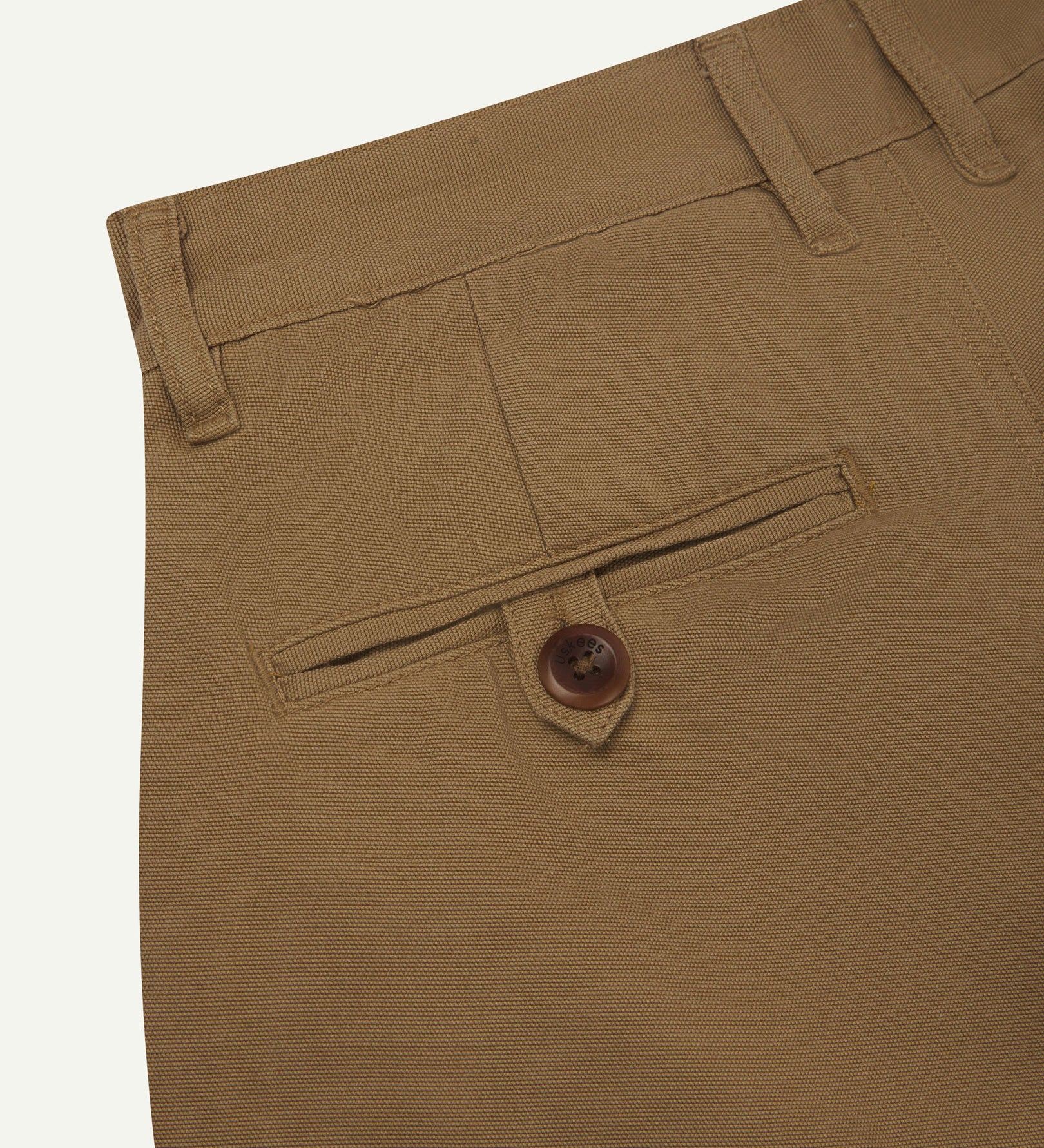 Back close-up view of 5018 Uskees men's organic mid-weight cotton boat trousers in acid khaki showing belt loops and buttoned back pocket.