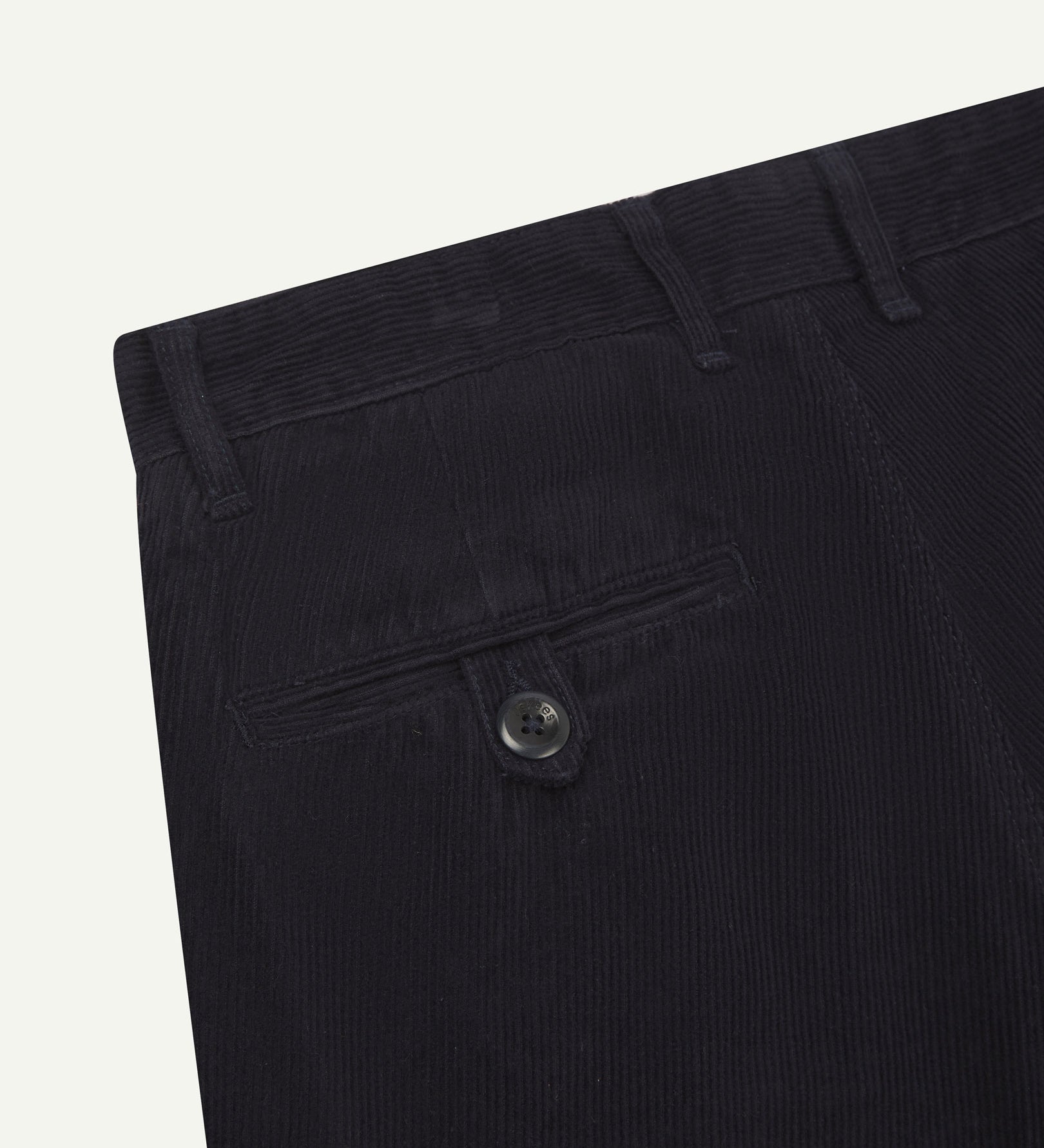 Close up back shot of Uskees 5018 cord boat pants in midnight blue with focus on neat back pocket secured with Corozo button and belt loops.