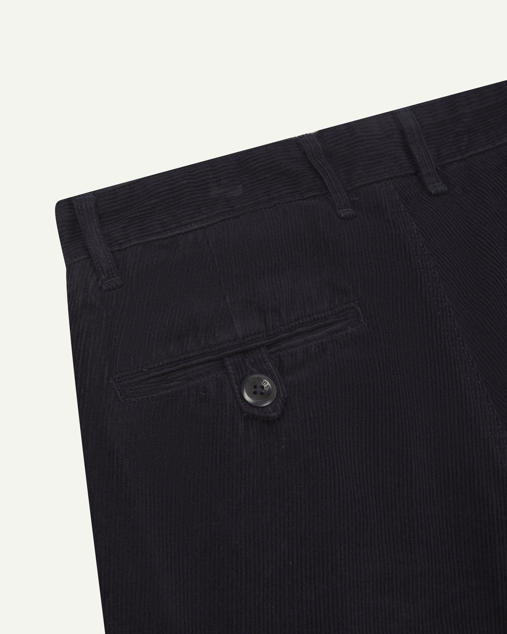 Close up back shot of Uskees 5018 cord boat pants in midnight blue with focus on neat back pocket secured with Corozo button and belt loops.