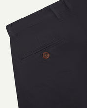 Back close-up view of 5018 Uskees men's organic mid-weight cotton boat trousers in acid midnight blue showing belt loops and buttoned back pocket.