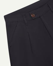 Front close-up shot of 5018 Uskees men's organic mid-weight cotton boat trousers in midnight blue showing corozo button fastening at waistband, belt loops and front pocket.