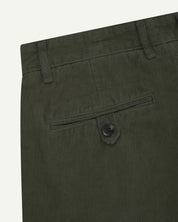 Close up back shot of Uskees 5018 cord boat pants in vine green with focus on neat back pocket secured with Corozo button and belt loops.