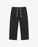 Front flat view of 5020 ripstop utility pants in black. Indicating drawstring, tapered fit on the leg, deep front pockets and reinforced knee patches. 