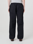 Back view of model wearing 5020 ripstop utility pants in black. Indicating relaxed fit, two jetted pockets and length falling just above the ankle.