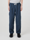 Front view of model wearing 5020 drill utility pants in blueberry. Indicating tapered fit on the leg, deep front pockets and reinforced knee patches. 