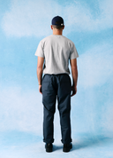 Back view of model wearing 5020 ripstop utility pants in blueberry. Indicating two jetted pockets.