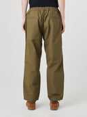 Back view of model wearing 5020 ripstop utility pants in ivy green. Indicating relaxed fit, two jetted pockets and length falling just above the ankle.