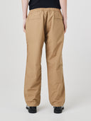 Back view of model wearing 5020 ripstop utility pants in khaki. Indicating relaxed fit, two jetted pockets and length falling just above the ankle.