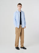 Full-length view of model wearing 5020 ripstop utility pants in khaki, paired with Uskees shirt.