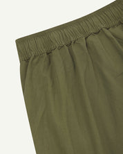 Back close-up shot of Uskees 5020 olive-green lightweight utility pants showing elasticated waist.