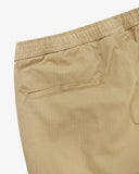 Close-up of light brown ripstop pants for men showing the waistband and back pocket on a white background