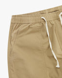 Beige ripstop trousers showing waist drawstring and pocket on a white background