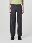 Close-up front view modelling 5021 Uskees men's organic twill charcoal grey painter pants highlighting relaxed, flattering fit.