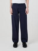 Close-up front view modelling 5021 Uskees men's organic twill midnight blue painter pants highlighting relaxed, flattering fit.