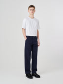Full-length view modelling 5021 Uskees men's organic twill midnight blue painter pants paired with Uskees plain white t-shirt.