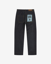 Full-length back view of Uskees 5021 raw orta denim workwear pants in dark indigo showing belt loops, back pockets with 'Raw Orta' cardboard pocket plaster.