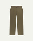 Front flat view of Uskees barrel leg pants in dark taupe. Showing Corozo button fastening, baggy fit with tapered cuff.