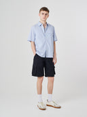 Full-length front view of male model wearing 5023 men's ripstop cargo shorts in black, paired with Uskees casual short-sleeve shirt.
