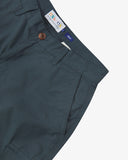 Close up front view of the front side pocket, branding label, corozo button and belt loops of the blueberry ripstop shorts from Uskees.