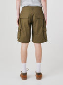 Bottom-half back view of male model wearing ivy green 5023 men's ripstop cargo shorts with clear view of flapped back pockets, side cargo pockets and relaxed look.