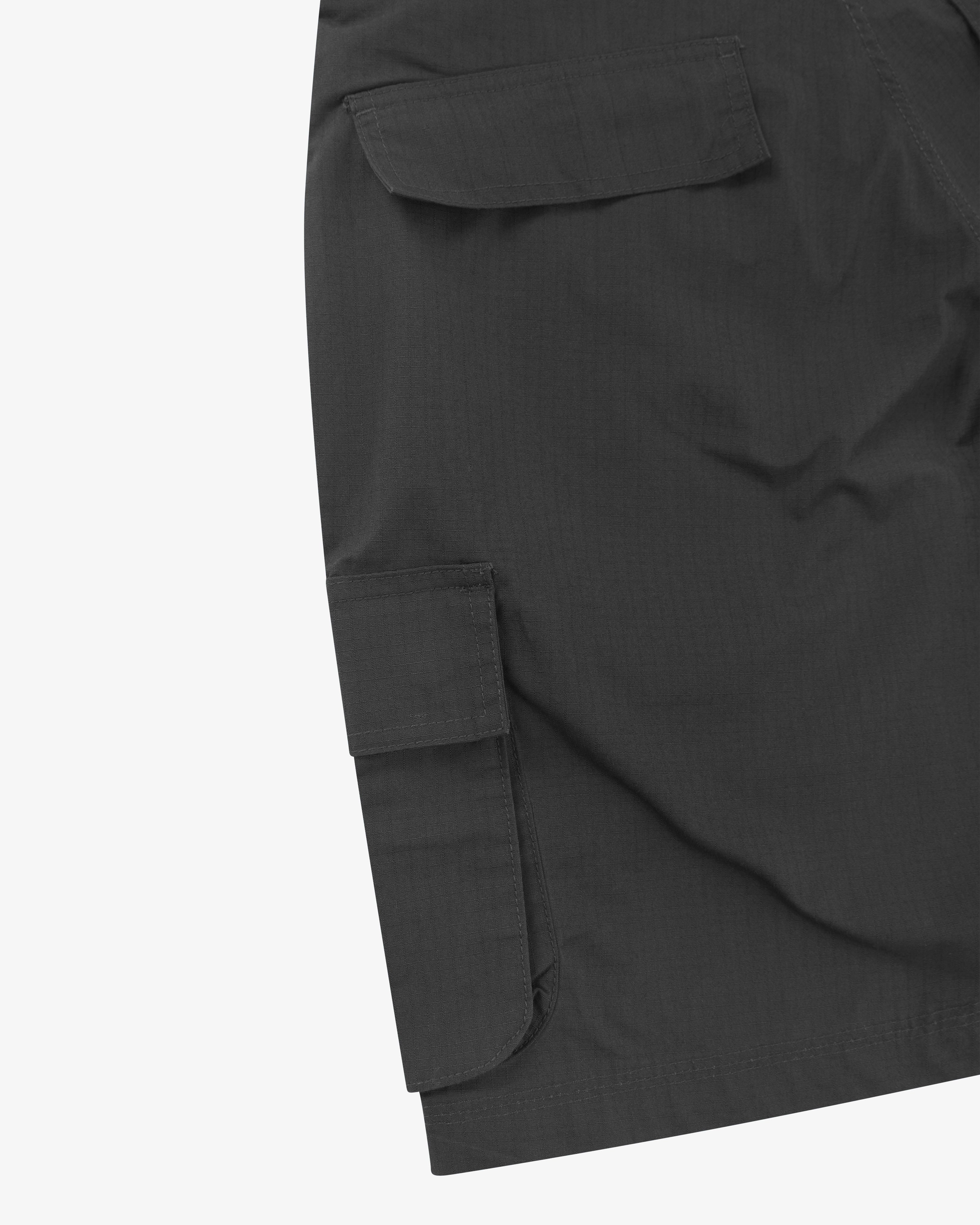 Close-up back view of black 5023 men's ripstop cargo shorts. Clear view of a cargo pocket with flap and the weave of the ripstop fabric.