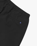 Close up view of the jetted back pocket and the waistband of the black ripstop shorts from Uskees.