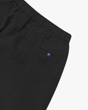 Close up back view of the jetted back pocket, elasticated waist and small Uskees tab label of the black ripstop shorts.