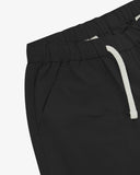 Close up front view of the front side pocket, elasticated waist and drawstring of the black ripstop shorts from Uskees.