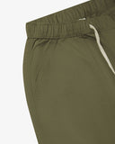 Close up front view of the front welt pocket, elasticated waist and tie of the ivy green ripstop shorts from Uskees.