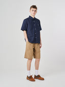 Full-length front view of male model wearing 5024 men's ripstop utility shorts in khaki, paired with dark blue short-sleeve shirt.